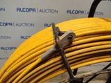 a close up of a yellow hose with a pair of scissors on it