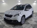 the small white car is parked in a large room