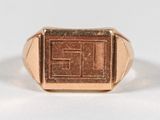 an image of a gold signet ring with the letter e on it