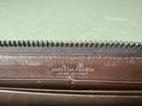 the inside of a brown purse with a zipper on it
