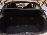 a car with its trunk open in a garage