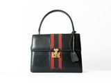 a black purse with a red and black stripe on it