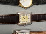 three different types of watches on display in a display case