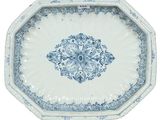 a blue and white plate with a floral design on it