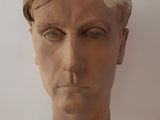 a clay head of a man with a turban on his head