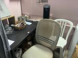 a desk with a chair and a computer on it