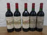 quatre bouteilles de vin sont alignées sur une table