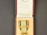 an image of a medal in a red box on a table