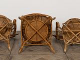 three wicker chairs sitting next to each other on a tiled floor