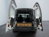 a white van with its doors open in a room