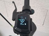 a digital clock mounted on the handlebar of a bike