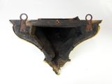an old wooden shelf with two hooks attached to it