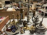a lot of silver and brass items on a table