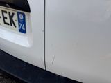 a close up of a white car with a license plate on it