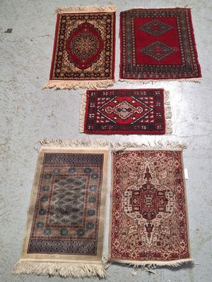four rugs are laid out on the floor in a room