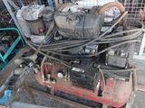 a small engine that is on a cart in the yard