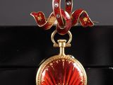 an image of a red and gold locke with a ribbon around it