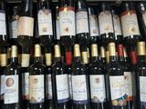 many bottles of wine sitting on a shelf in a store