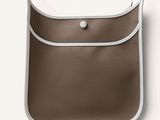 a brown and white bag with a button on it