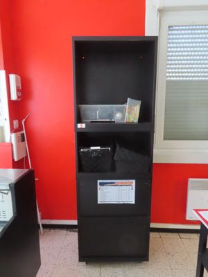 an image of a small office with a red wall