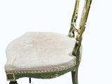 an image of a green chair with a white cushion on it