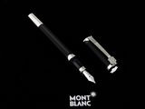 a black pen and a silver pen on a black background
