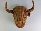 a wicker bull head mounted on the wall