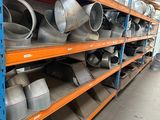 a large amount of metal pots and pans on the shelves