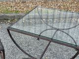 a glass table with a metal frame and a glass top