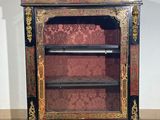 an antique black and gold painted cabinet with shelves and shelves