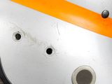 a close up of a metal object with orange tape on it