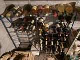 many bottles of wine sitting on a rack in a room