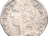 a silver coin with an image of a woman ' s head on it
