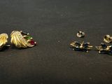 two pairs of earrings and a pair of earrings on a table