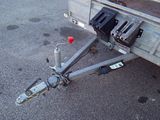 a trailer with a trailer hitched to it on the street