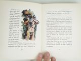 a person holding an open book with a picture of a woman