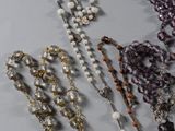 many different types of rosary beads on a table
