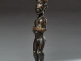 a bronze statue of a woman holding a baby