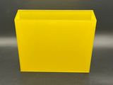 a close up of a yellow planter sitting on a table