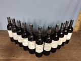 several bottles of wine are lined up on a wooden table
