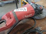a red and black electric tool sitting on a table