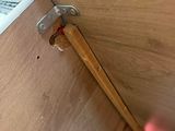 a close up of a piece of wood with a hammer sticking out of it