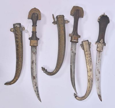 four different types of knives are displayed on a white surface