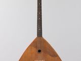 a close up of a wooden instrument hanging from a ceiling
