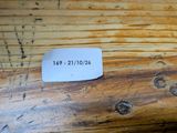 a label on a piece of wood that has been scratched