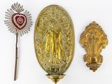 three pieces of gold and red brooches on a white surface