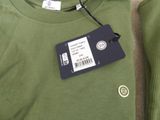 a green shirt with a tag attached to it