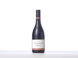 a bottle of red wine sitting on top of a table