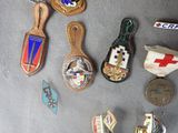 a lot of badges that are laying on a table