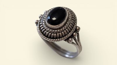 a silver ring with a black stone in the center